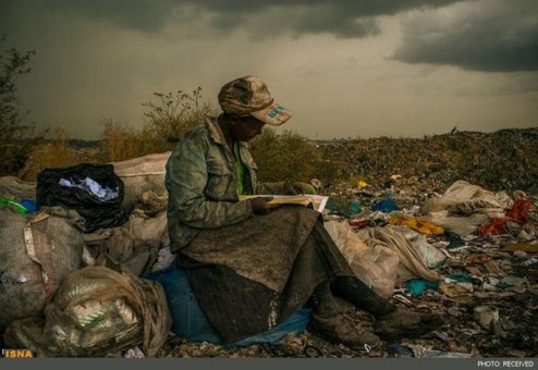زن آشغال جمع کن اهل ایالت نایروبی کنیا که در قبرستان زباله ها در حال مطالعه است. (عکاس: میکا آلبرت آمریکایی)
