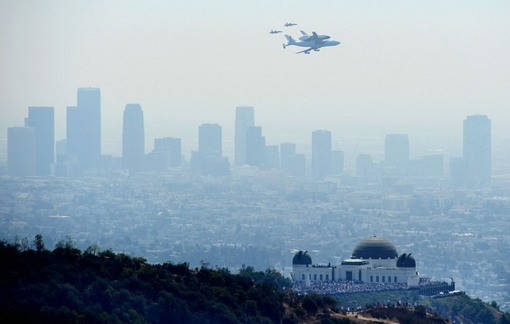 پنج ساعت قبل از فرود در فرودگاه بین المللی لس آنجلس، شاتل بازنشسته از فراز رصدخانه پارک گریفیث عبور می کند تا با کاهش سرعت، از بالای خیابان های شهر عبور کند و یادگاری از خود در اذهان به جا بگذارد. (Joe Klamar/AFP/Getty Images)