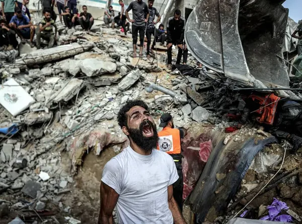 شهر غزه ـ تصویر گرافیکی از عزاداری مرد فلسطینی؛ در حالی که تیم&zwnj;های دفاع مدنی و ساکنان به دنبال افرادی هستند که پس از حمله هوایی اسرائیل به اردوگاه آوارگان الشطی در میان آوار گرفتار شده&zwnj;اند.