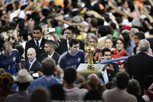 Argentina player Lionel Messi watches the World Cup trophy go by at Maracana Stadium