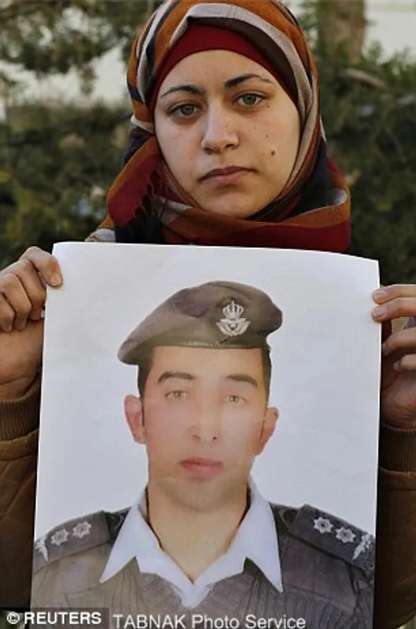 Grief: Anwar al-Tarawneh, the wife of Kasasbeh, appeared at a protest in Amman, Jordan yesterday morning calling for his release

