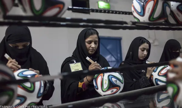 کارکنان بخش کیفیت و کنترل توپهای تولیدی برای جام جهانی فوتبال در برزیل / سیالکوت، استان پنجاب .